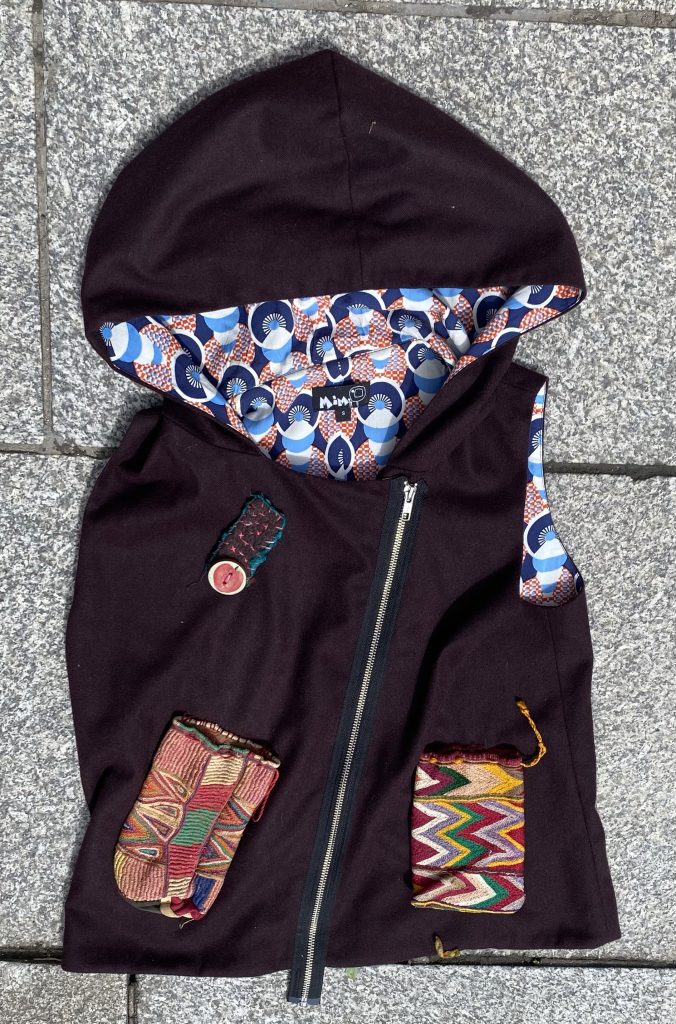 Sleeveless hoody, beautifully lined, embellished with embroidered pocket bags. Size: 10